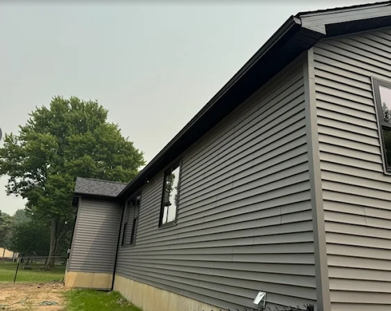 Gray horizontal siding installation along a residential exterior