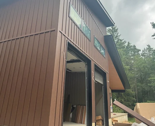 Custom workshop exterior clad in warm brown vertical metal siding